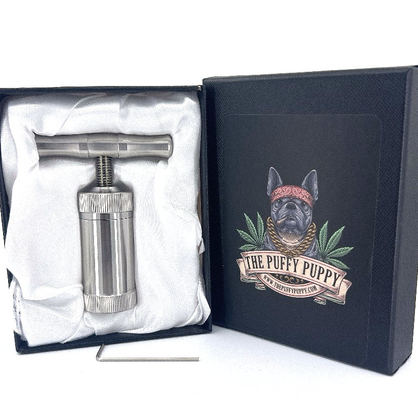 Pollen press made of heavy duty stainless steel with a black box.