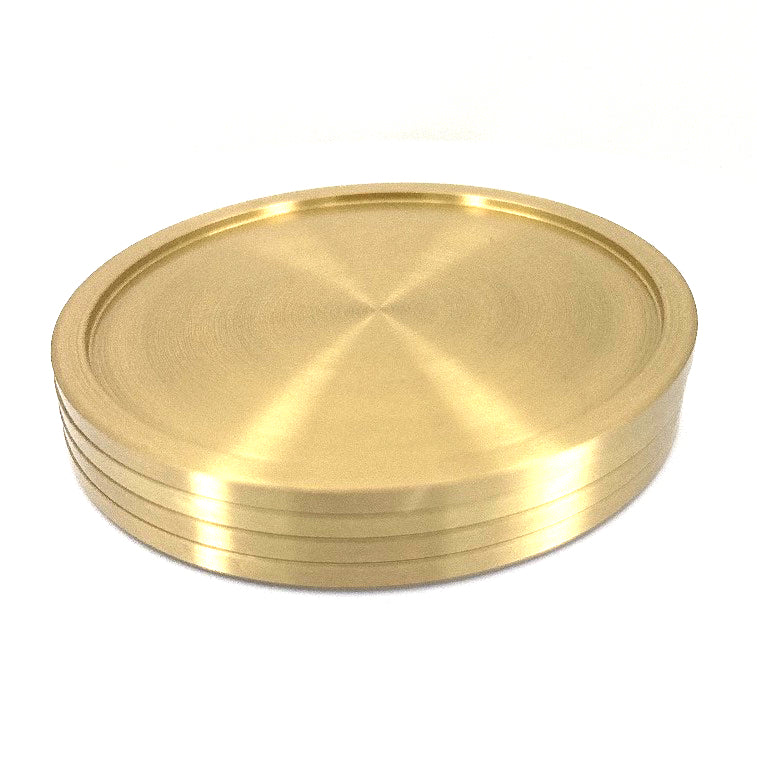 Four solid brass coasters for drinks.