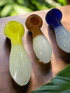 Three glass smoking pipes on a white surface