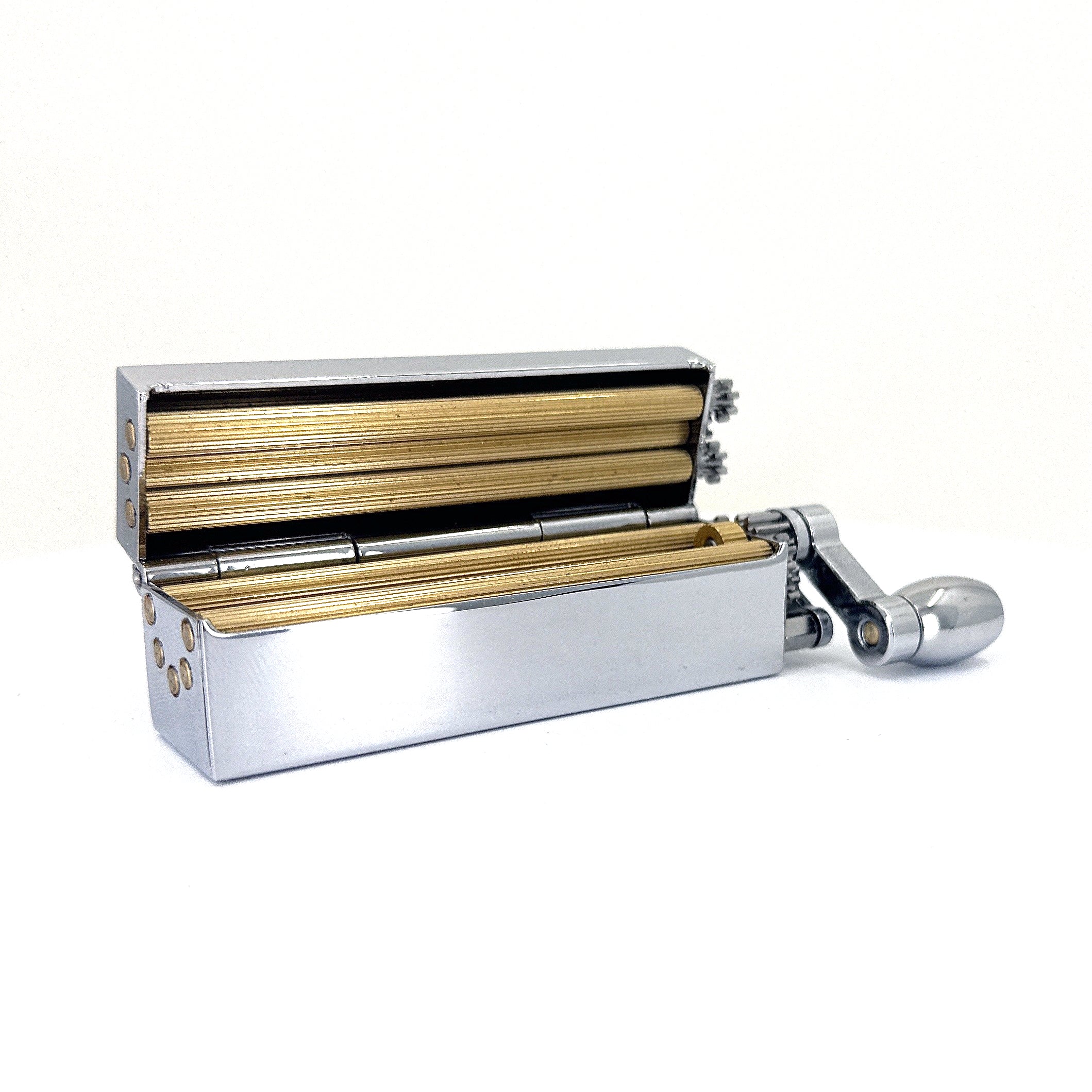 Joint roller with gold inner and silver outer chrome huey manual cigarette rolling machine.
