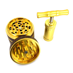 Gold four piece walnut grinder and gold pollen press.