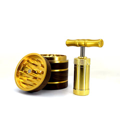 Gold four piece walnut grinder for weed and gold pollen press.