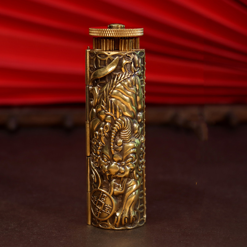 A standing carved gold brass rolling machine with engravings.