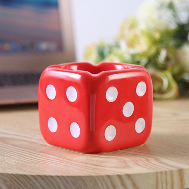 Red dice ashtray with white dots on the table.